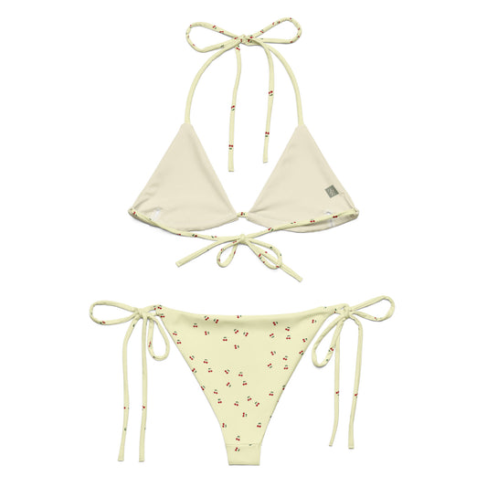 A yellow bikini set called the Cherry Orchard Bikini Set, made from high-quality, soft, and stretchy material with UPF 50+ sun protection. This eco-friendly bikini set is perfect for swimming, sunbathing, or poolside lounging. It comes in a wide range of