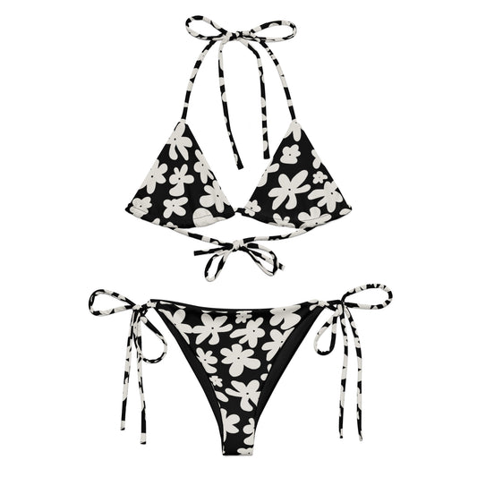 A stylish and comfortable bikini set called the Midnight Flower Bikini Set, made from high-quality, soft, and stretchy recycled material with UPF 50+ sun protection. This eco-friendly bikini set is perfect for swimming, sunbathing, or poolside lounging. I